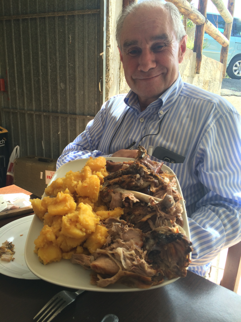 Conchita's husband Cito proudly displaying the lamb and potatoes